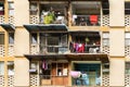 The balconies of an apartment building are hung with clothes. The poor area. Moments of Ordinary Life