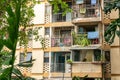 The balconies of an apartment building are hung with clothes. The poor area. Moments of Ordinary Life