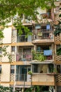 The balconies of an apartment building are hung with clothes. The poor area. Moments of Ordinary Life