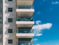 Balconies and blue sky with clouds. Part of a residential building in Israel. Royalty Free Stock Photo
