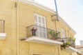 Balconies with flowers in a beautiful stone house. Close-up. View from below Royalty Free Stock Photo