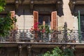 Balconies with flowers of the one of old buildings in modern style in the historical center of Barcelona in sunny day. Spain Royalty Free Stock Photo