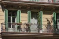 Balconies with flowers of the one of old buildings in modern style in the historical center of Barcelona in sunny day. Spain Royalty Free Stock Photo