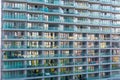 Balconies glass modern building. Residential and inhabited with household items apartment building. Front view close up. Royalty Free Stock Photo