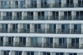 Balconies of passengers cabins in aft part of huge cruise ship of white color moored in port of Caribbean Island. Royalty Free Stock Photo