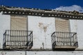 Balconies and windows closed shutters in an old two-story house in the Mediterranean style cracked walls Royalty Free Stock Photo