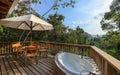 Balcony bath tub and table at Caves Branch Jungle Lodge