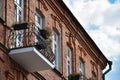 Balcony with flowers on an old brick building in the historic center of the city