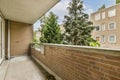 a balcony with a brick wall and a large window Royalty Free Stock Photo