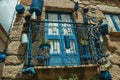 Balcony decorated with lots of blue pans on stone house facade Royalty Free Stock Photo