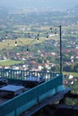 A balcony at a dining and hangout spot on the edge of a cliff, providing a breathtaking view of the city from a hilltop.