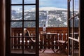 Balcony door offers a gorgeous view of a snow-capped mountain and ski lift and cloudy sky, Austria