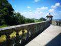 Balcony of a fabulous palace in classical style with a view of the green landscape