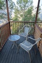 Balcony having wooden railing and easy chairs Royalty Free Stock Photo