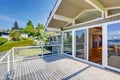 Balcony house exterior with glass railings and nice view.