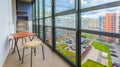 Balcony interior with chairs and table of modern apartment with a view on the courtyard. Royalty Free Stock Photo