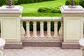 A balcony with stone pedestals and railings with balustrades.