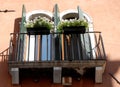 Balcony with symmetries of windows and flowers in Venice. Royalty Free Stock Photo