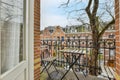 a balcony with a table and chairs and a window Royalty Free Stock Photo