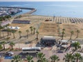 Balcony view over the Palm trees promenade, bus station, sea and port in Larnaca town Royalty Free Stock Photo