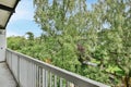 a balcony with a view of trees and a yard