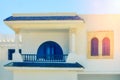 Balcony and windows of a white arabic house with blue shutters Royalty Free Stock Photo