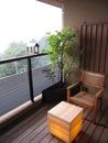 Balcony with wooden chair, tree plant, and lantern lamp table at the Japanese traditional inn hotel