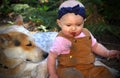 Bald Baby Eating Dirt with Doggie