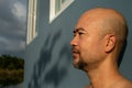 Bald beard 40s portrait man on blue wall cement background