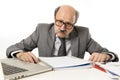 Bald business man 60s working stressed and frustrated at office computer laptop desk looking tired Royalty Free Stock Photo