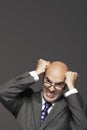 Bald Businessman With Fists Pounding Bald Head