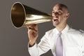Bald Businessman Shouting Through Megaphone Royalty Free Stock Photo