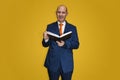 Well-dressed bald man reading a book Royalty Free Stock Photo