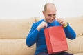 Man looking inside into a red bag Royalty Free Stock Photo