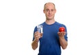 Bald Caucasian man holding glass of water and red apple Royalty Free Stock Photo