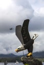 Bald Eagle statue in Ketchikan with float plane in sky Royalty Free Stock Photo