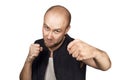 Bald evil guy criminal extortionist preparing for a fight and swinging his fist Royalty Free Stock Photo