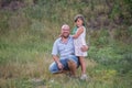 Bald father in glasses hugs daughter with green hair in nature. Diversity family portrait smilling