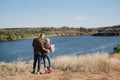 Bald guy with a beard and a blonde girl are looking at the map and looking for Royalty Free Stock Photo