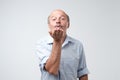 Bald handsome mature male blows air kiss, expresses his devotion and truthful love to his wife Royalty Free Stock Photo