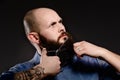 Bald man with a beard shortens his beard Royalty Free Stock Photo