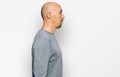 Bald man with beard wearing casual clothes looking to side, relax profile pose with natural face with confident smile Royalty Free Stock Photo