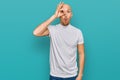 Bald man with beard wearing casual white t shirt doing ok gesture shocked with surprised face, eye looking through fingers Royalty Free Stock Photo