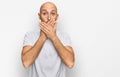 Bald man with beard wearing casual white t shirt shocked covering mouth with hands for mistake Royalty Free Stock Photo