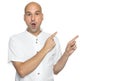 Bald man in casual white shirt is pointing fingers. Isolated Royalty Free Stock Photo