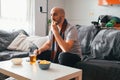 Young man eating chips while watching sports on the sofa Royalty Free Stock Photo