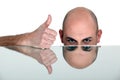 Bald man giving thumbs-up