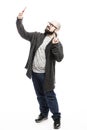 A bald man with glasses and a beard takes a selfie on the phone. Full height. Isolated on a white background.