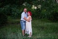 Bald man in glasses embrace with tenderness woman with pink hair in green forest. Diversity Couple Royalty Free Stock Photo