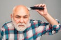 Bald man hairclipper, Mature baldness and hair loss concept. Middle aged gray man.